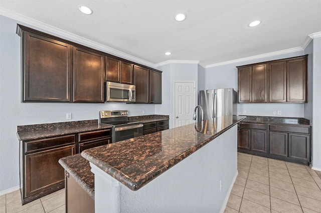 kitchen featuring dark brown cabinetry, an island with sink, and appliances with stainless steel finishes