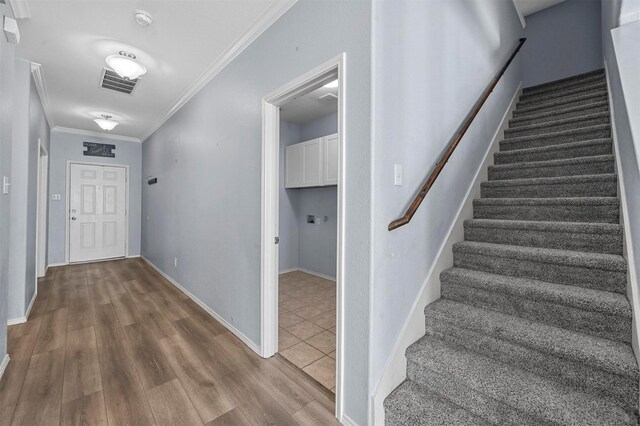 interior space featuring crown molding and hardwood / wood-style flooring