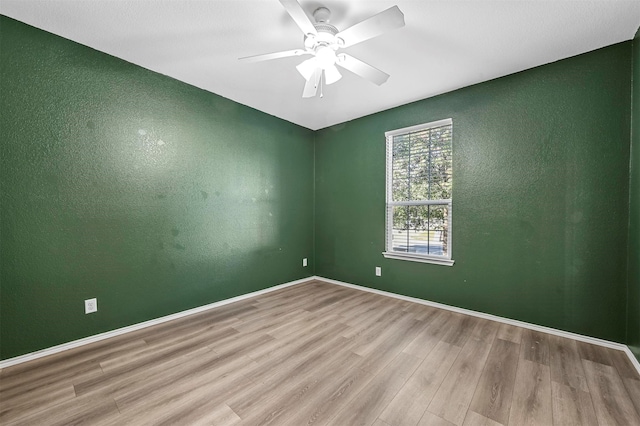 spare room featuring ceiling fan and light hardwood / wood-style flooring