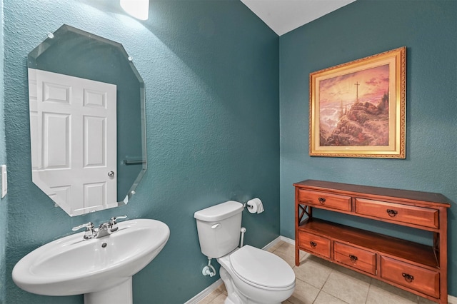 bathroom featuring tile patterned floors, toilet, and sink