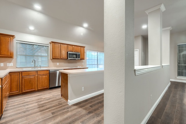 kitchen with sink, hardwood / wood-style floors, and appliances with stainless steel finishes