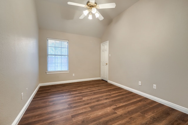 spare room with ceiling fan, dark wood-type flooring, and vaulted ceiling