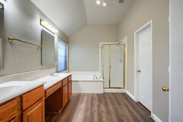 bathroom with hardwood / wood-style flooring, vanity, independent shower and bath, and vaulted ceiling