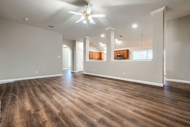 unfurnished living room with ceiling fan and dark wood-type flooring