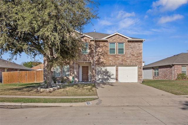 view of front property featuring a garage and a front yard