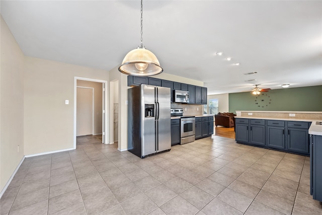 kitchen with blue cabinetry, ceiling fan, decorative light fixtures, and appliances with stainless steel finishes