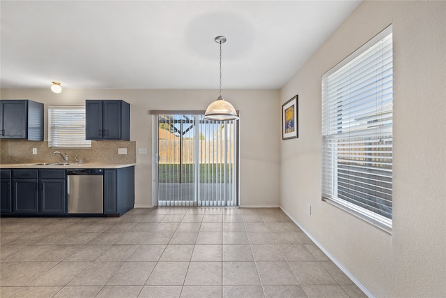 kitchen featuring decorative backsplash, stainless steel dishwasher, sink, light tile patterned floors, and hanging light fixtures