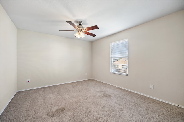 spare room with carpet and ceiling fan