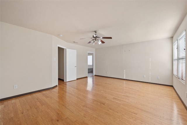 empty room with light wood-type flooring and ceiling fan