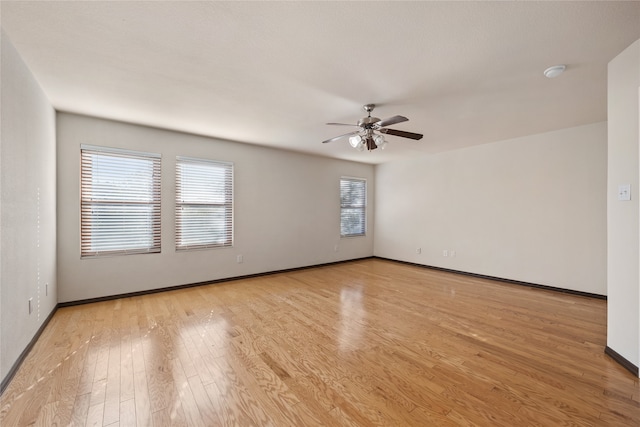 spare room featuring ceiling fan and light wood-type flooring