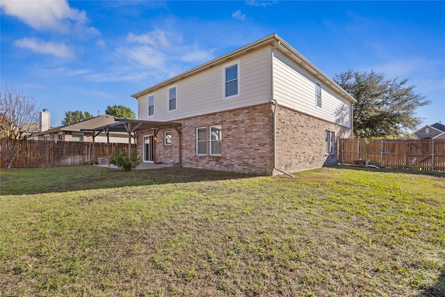 back of house featuring a lawn