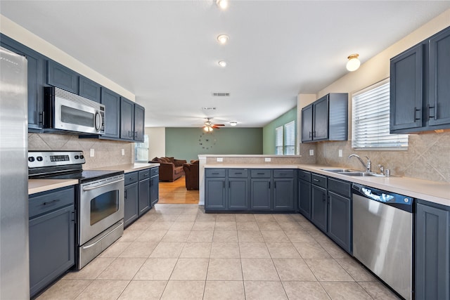 kitchen with blue cabinetry, ceiling fan, sink, and appliances with stainless steel finishes