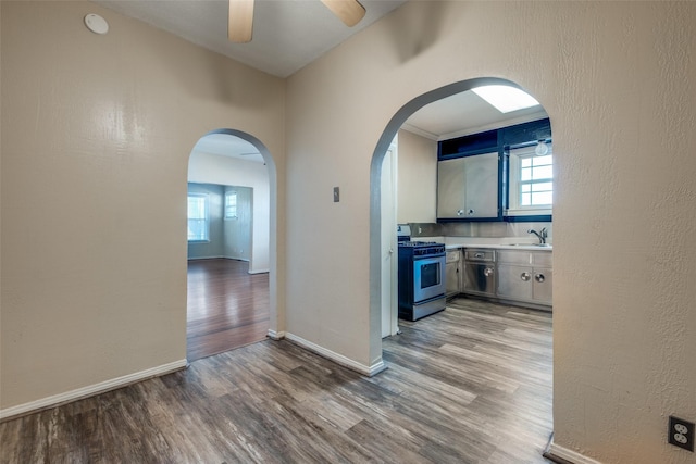 hallway featuring hardwood / wood-style flooring and sink