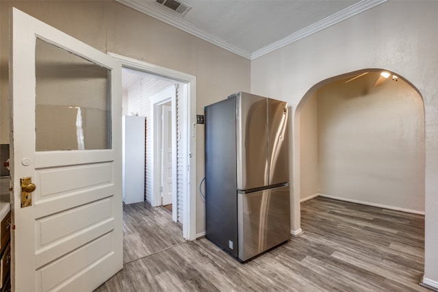 interior space featuring ornamental molding and hardwood / wood-style flooring