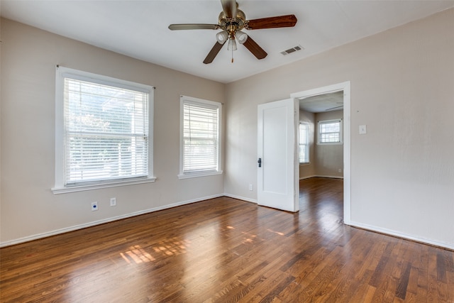 spare room with ceiling fan and dark hardwood / wood-style floors