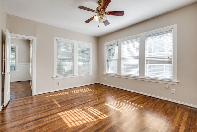 unfurnished room with plenty of natural light, dark hardwood / wood-style floors, and ceiling fan