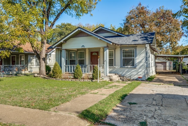 bungalow-style home with a carport, covered porch, and a front yard