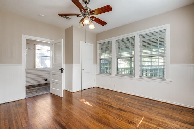 unfurnished room featuring dark hardwood / wood-style floors and ceiling fan