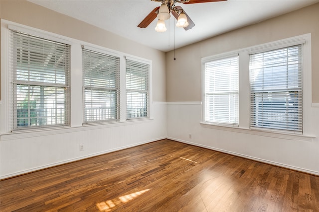 empty room with hardwood / wood-style flooring and ceiling fan