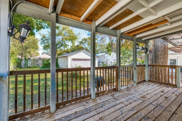 wooden deck featuring an outbuilding and a garage