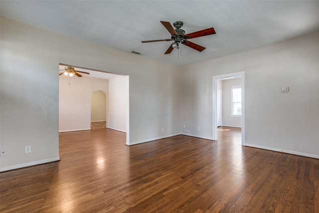 spare room featuring ceiling fan and dark hardwood / wood-style flooring