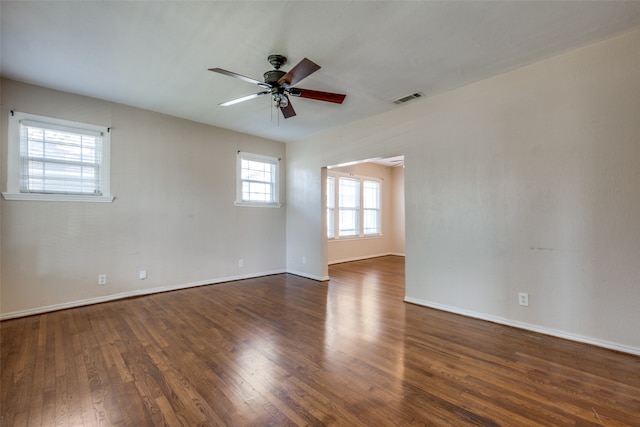 unfurnished room featuring ceiling fan and dark wood-type flooring