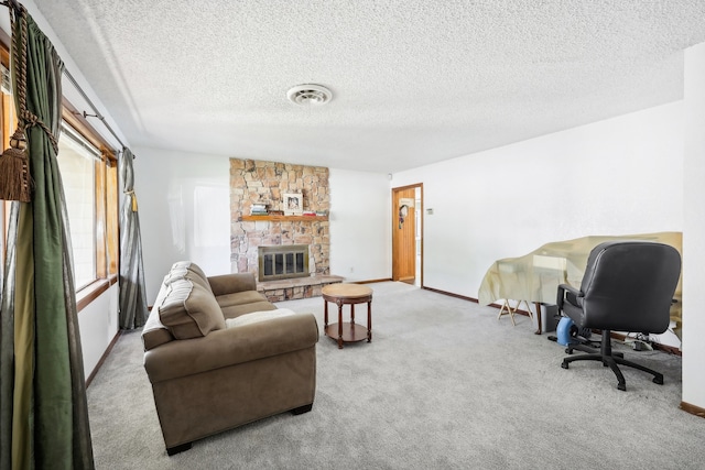 carpeted living room with a fireplace, a textured ceiling, and a healthy amount of sunlight