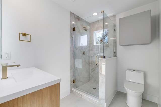 bathroom featuring tile patterned flooring, vanity, a shower with shower door, and toilet