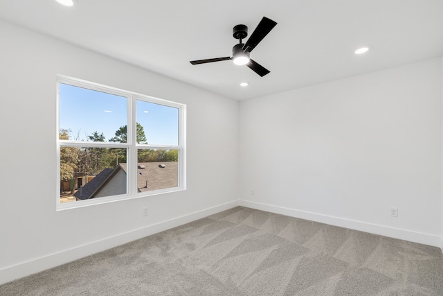 carpeted empty room featuring ceiling fan