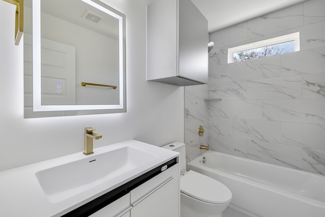 full bathroom featuring vanity, tiled shower / bath combo, and toilet