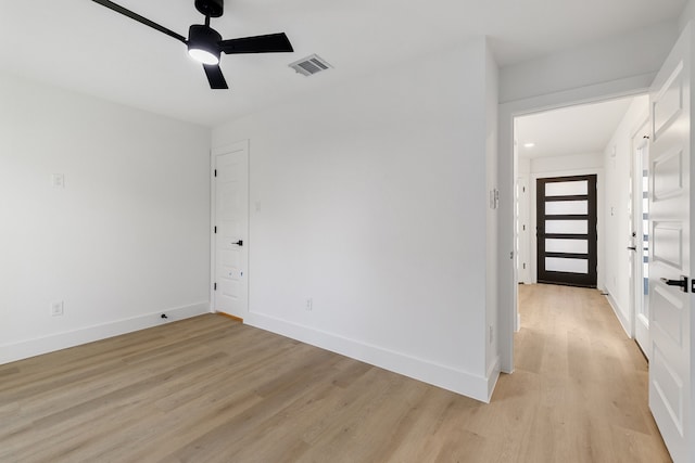 unfurnished room with light wood-type flooring and ceiling fan