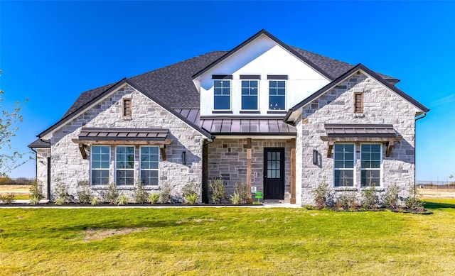5520 Gaelic Dr, Celina, TX 75009 - french country style house with a front lawn, stone siding, a standing seam roof, and a shingled roof