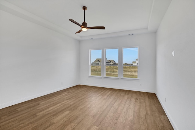 5520 Gaelic Dr, Celina, TX 75009 - empty room with wood finished floors, baseboards, a ceiling fan, and a tray ceiling