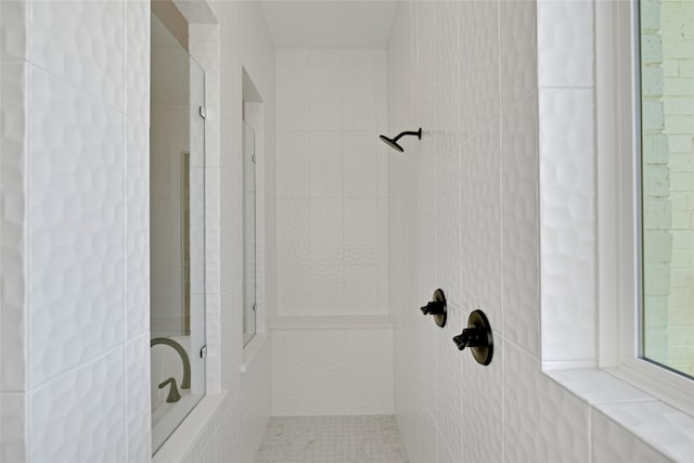 bathroom with tiled shower