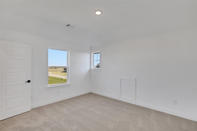 unfurnished room featuring light colored carpet