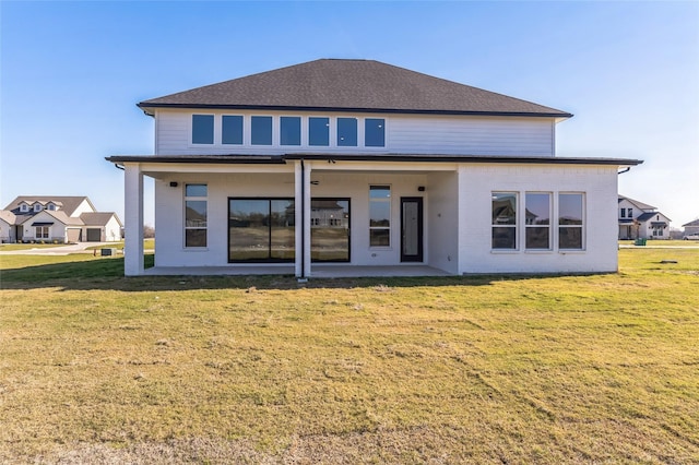 back of property featuring a yard and a patio