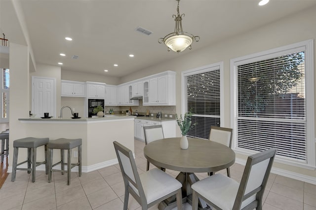 dining space featuring light tile patterned floors and a healthy amount of sunlight