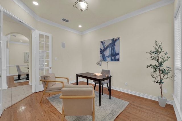 office area with light hardwood / wood-style flooring and ornamental molding