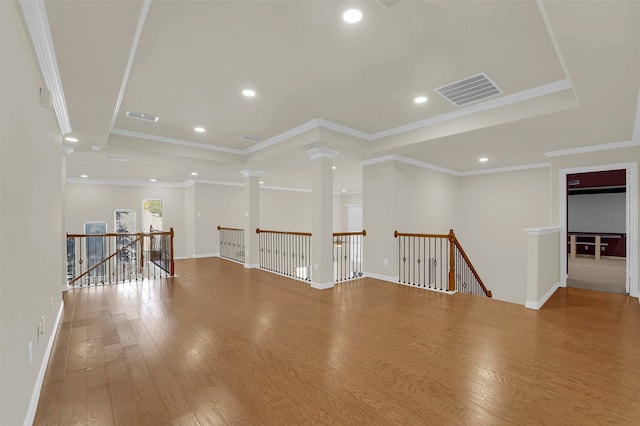 spare room featuring crown molding and hardwood / wood-style flooring