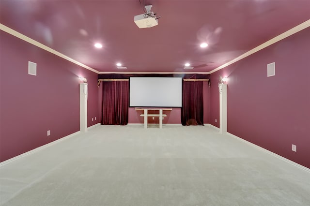 carpeted cinema room featuring ornamental molding