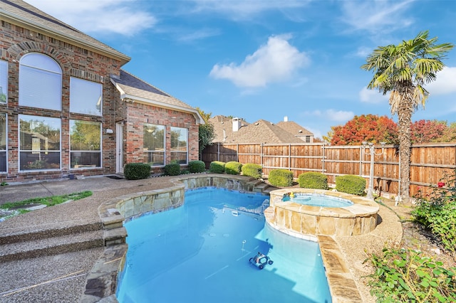 view of pool with an in ground hot tub