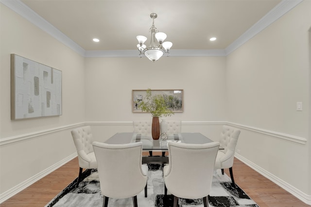 dining room with ornamental molding, a chandelier, and hardwood / wood-style flooring