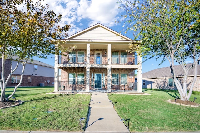 view of front of property featuring a balcony, a front lawn, and covered porch