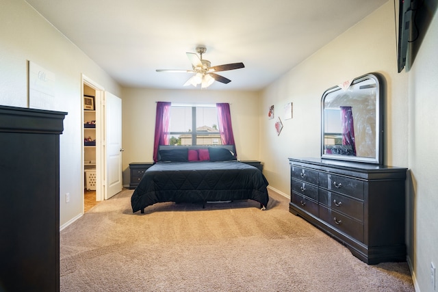 bedroom featuring ceiling fan and light carpet