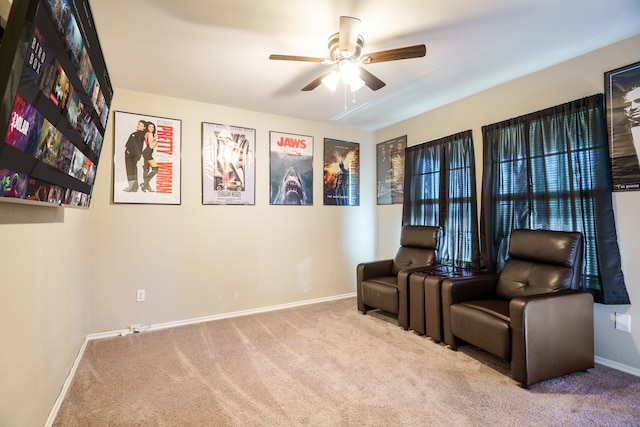 sitting room with ceiling fan and light colored carpet