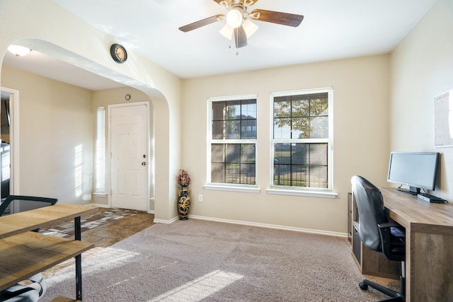 office space featuring light carpet and ceiling fan