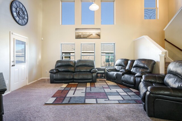 carpeted living room with a towering ceiling