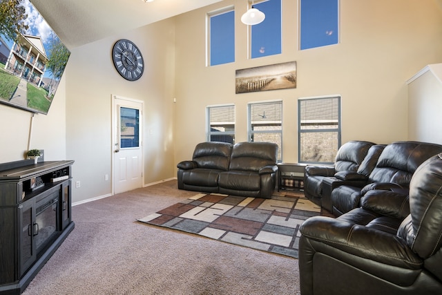 carpeted living room with plenty of natural light and high vaulted ceiling