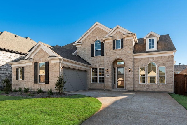 view of front facade with a garage and a front lawn