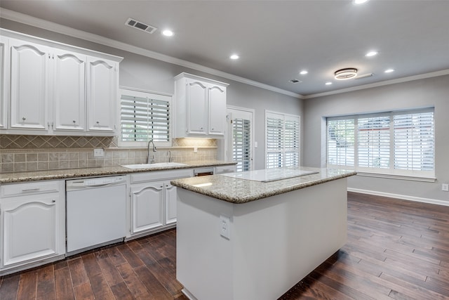 kitchen featuring white dishwasher, sink, a center island, dark hardwood / wood-style floors, and white cabinetry